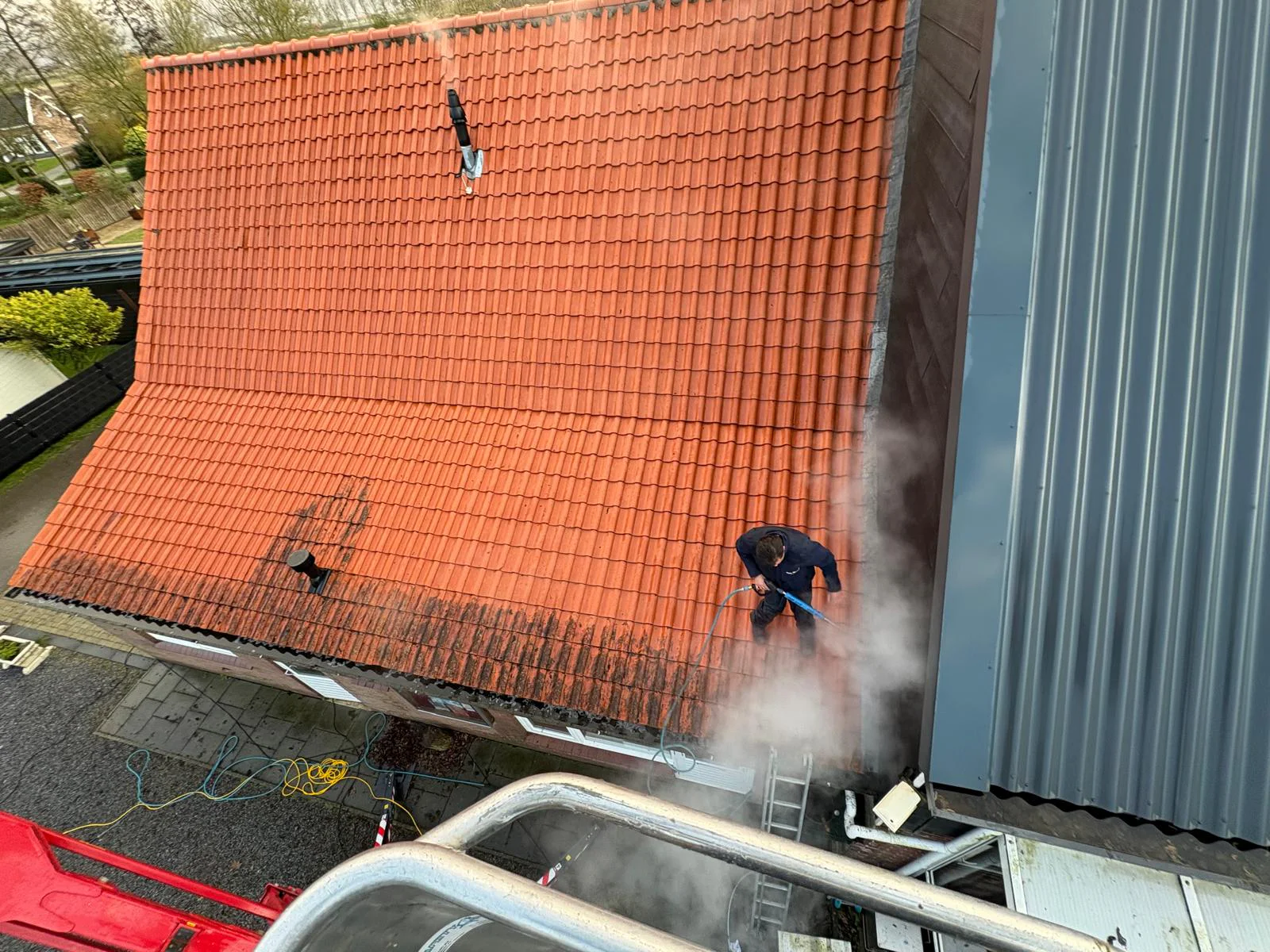 Specialist van CTM Cleaning reinigt een pannendak zorgvuldig